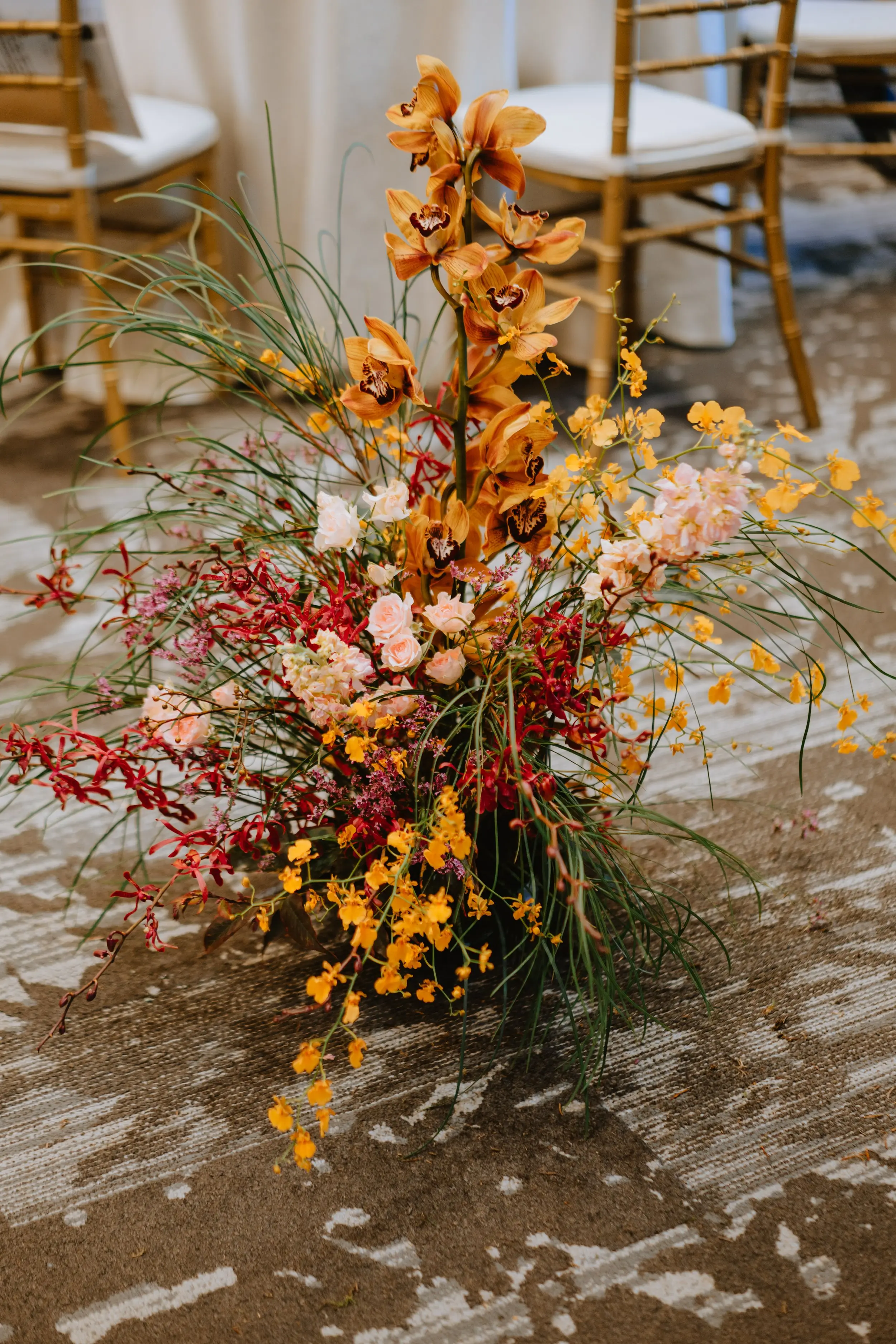 Hedges of boldly colored florals lined the aisle to welcome the celebrated union of CK & C.