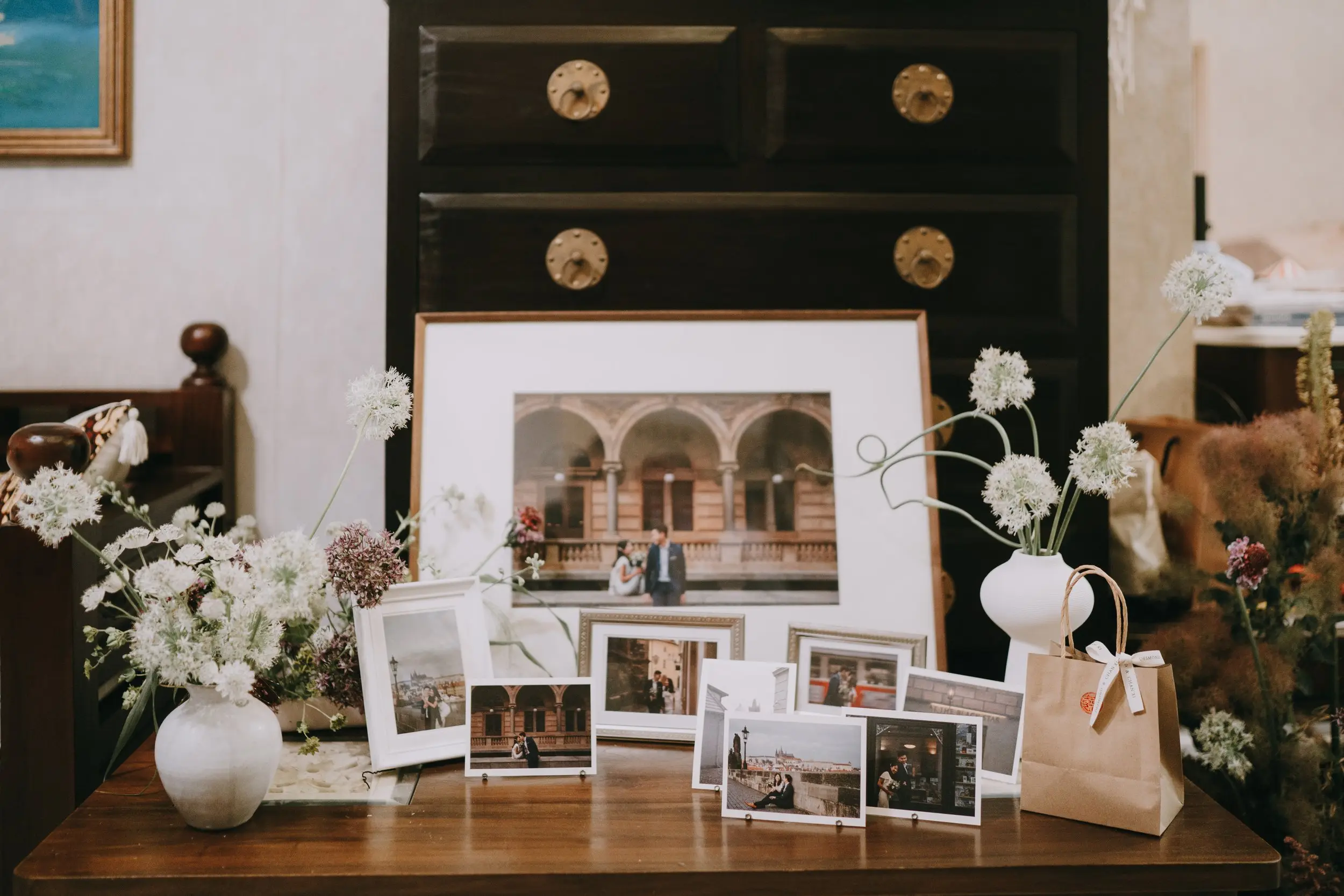 The photo display table captured their beautiful pre wedding shoot memories when they travelled to Prague. We kept the florals on the table minimal to complement the frames and not distract from the main focus.