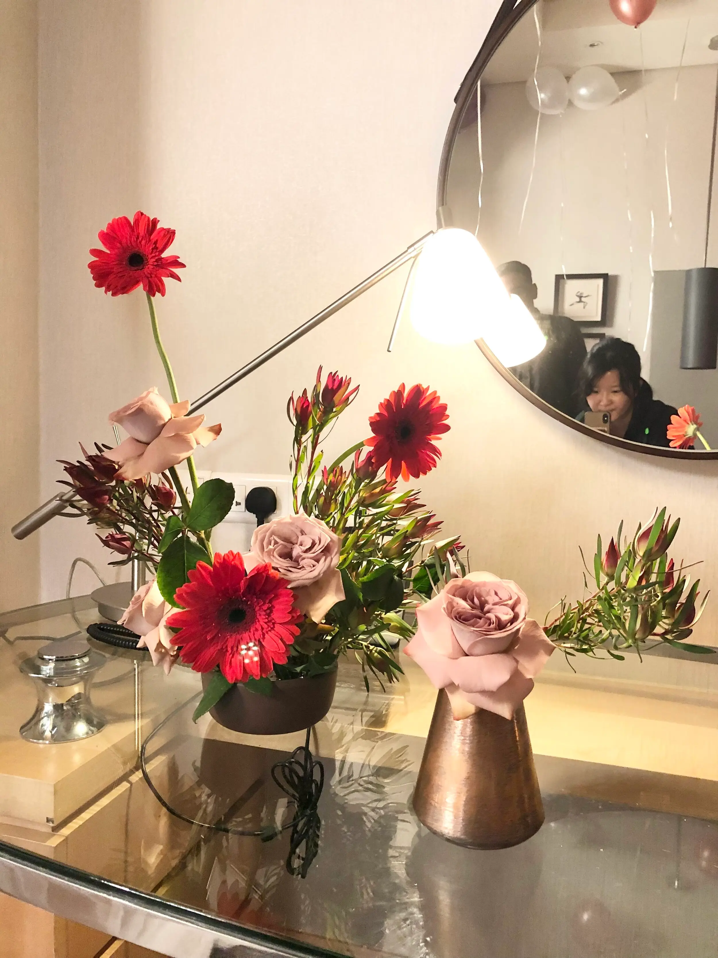 Pops of red gerbera daisies paired with neutral blush hues from cappuccino roses to complement the balloons. These florals were arranged into a flower bouquet after the proposal.