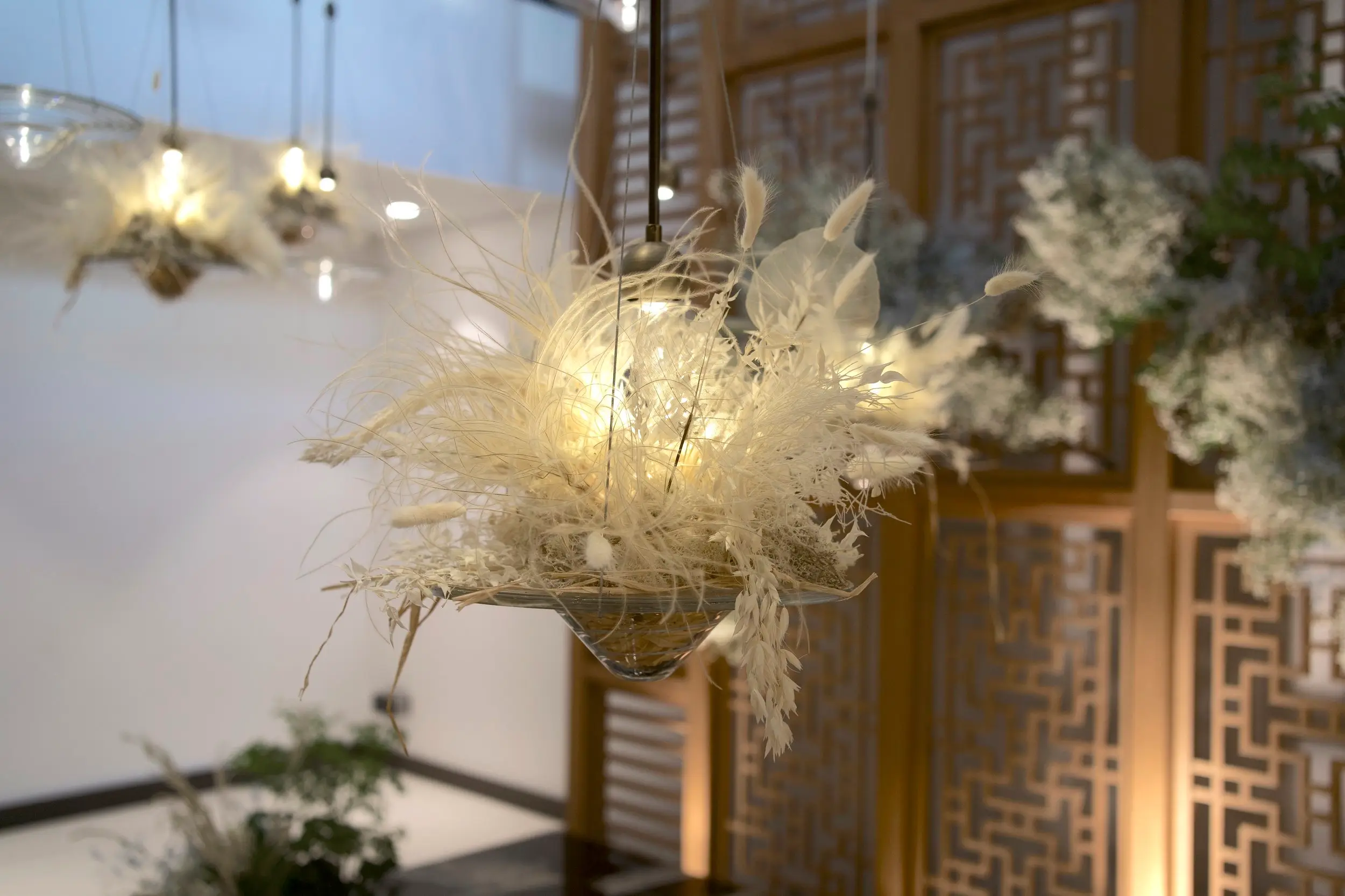 Clouds suspended in mid air were recreated using a mix of preserved florals and nested within the light installations.